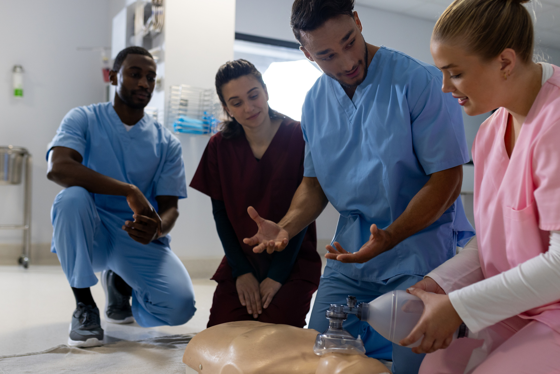 Healthcare trainees practicing CPR and emergency response techniques during workforce development training