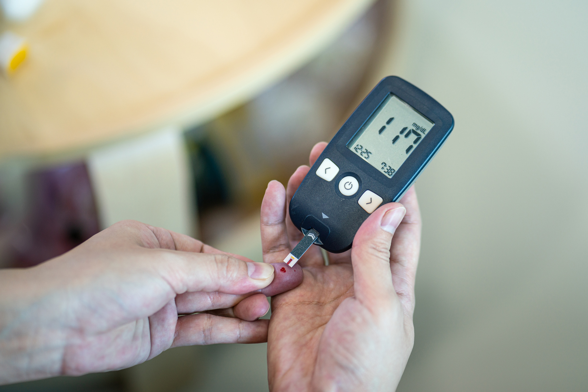 Close-up of a healthcare provider performing a finger-prick blood glucose test during a community diabetes screening
